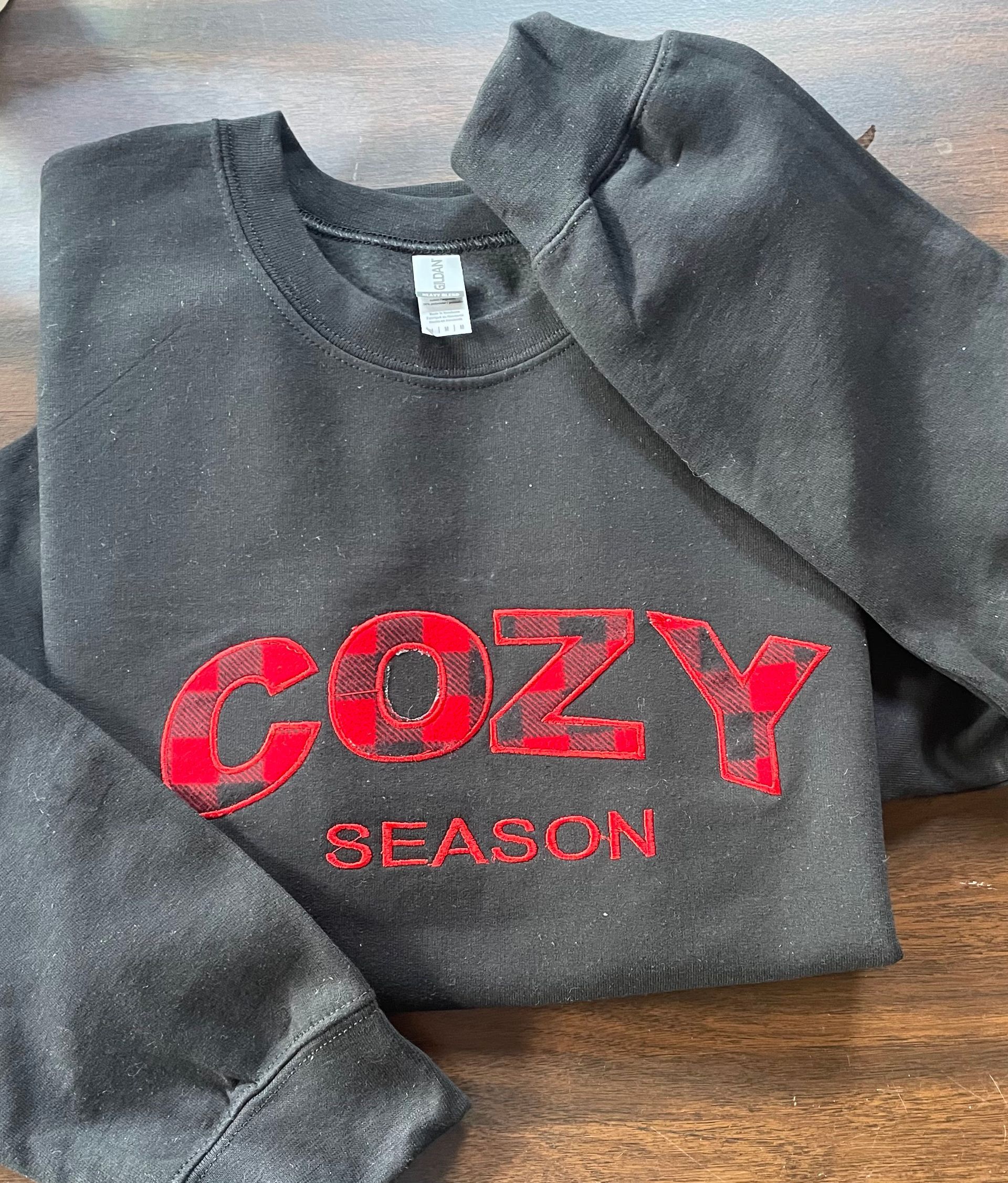 A dark gray long-sleeve shirt with the words 