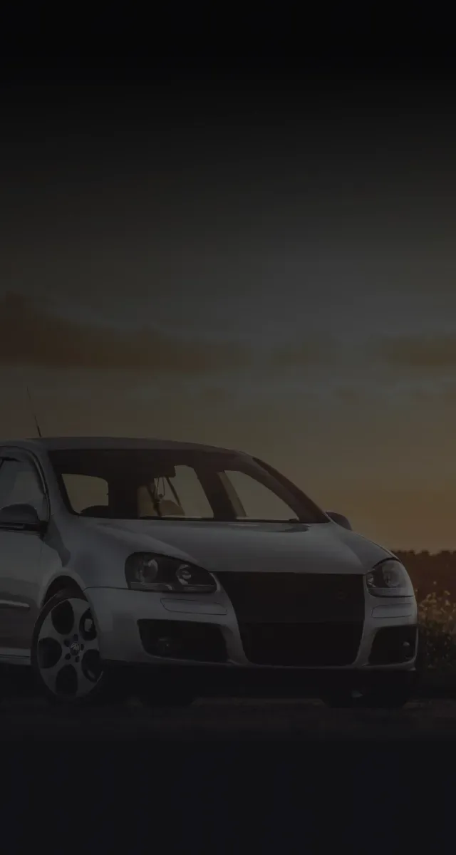 Silver car parked outside with sunset in background | Auto Brakes & Lube