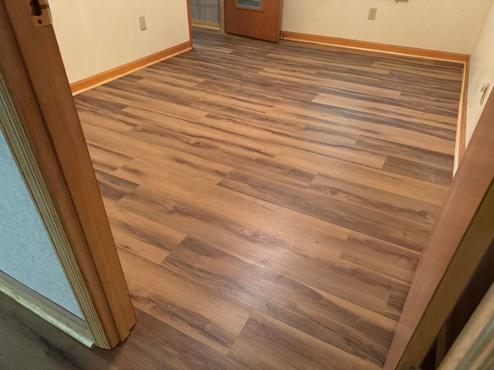 A room with a wooden floor and a door.