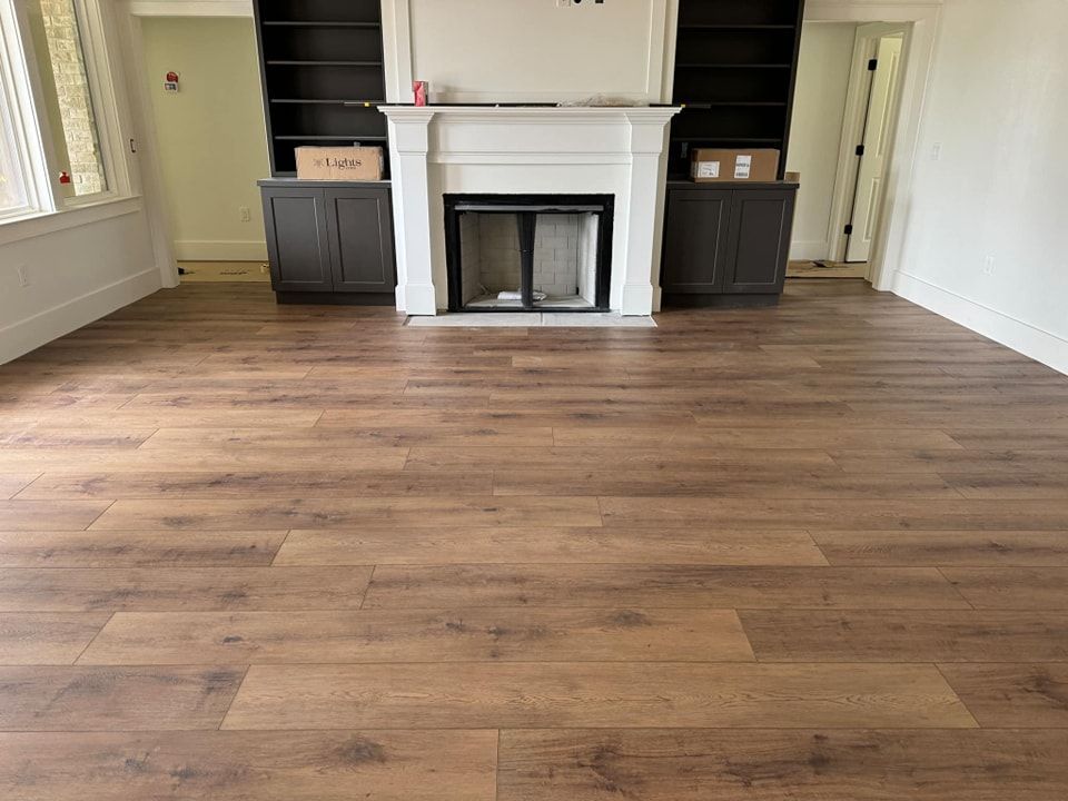 A living room with hardwood floors and a fireplace.