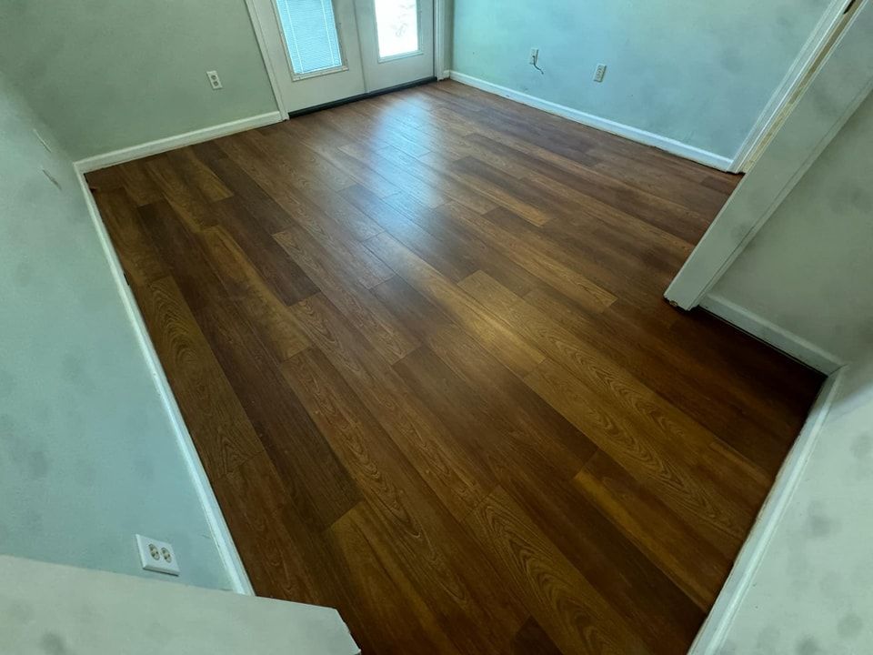 A room with hardwood floors and a door.