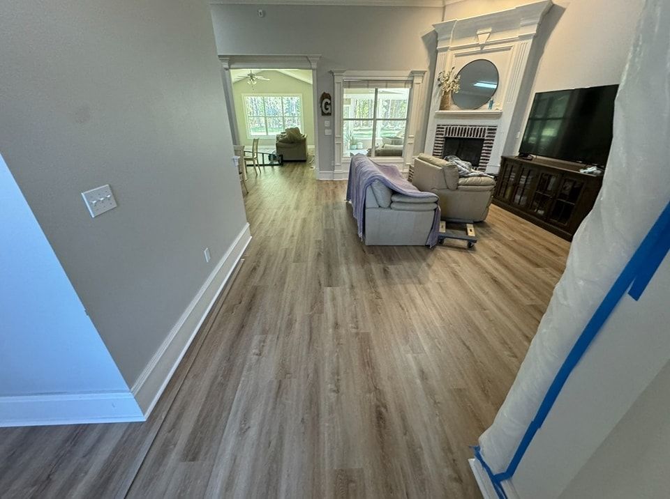 A living room with hardwood floors and a fireplace.