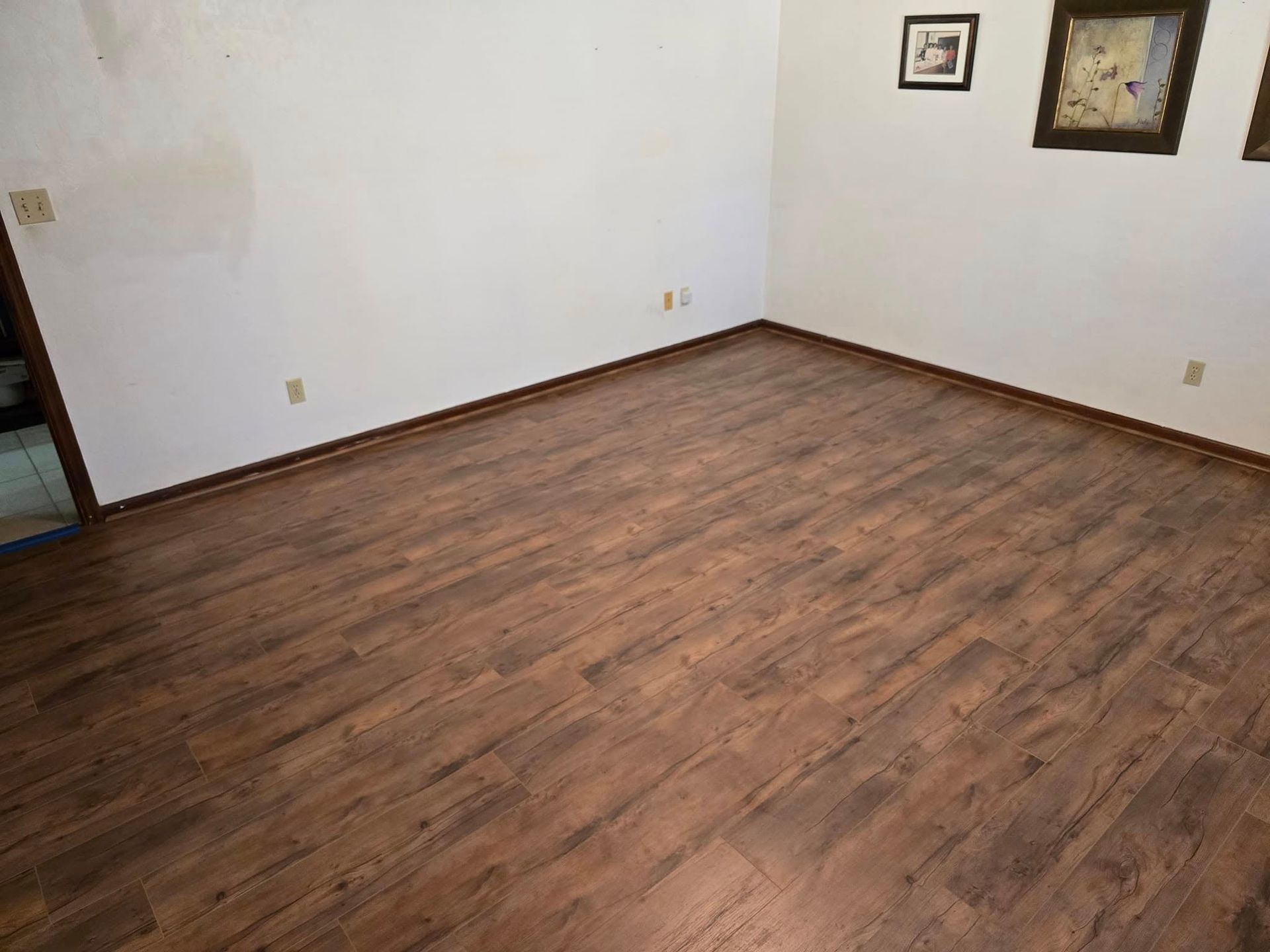 A room with a wooden floor and white walls.