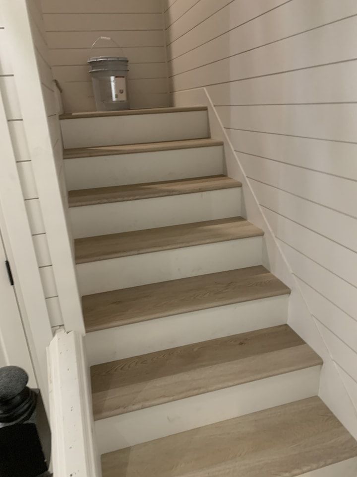 A set of wooden stairs leading up to a second floor.