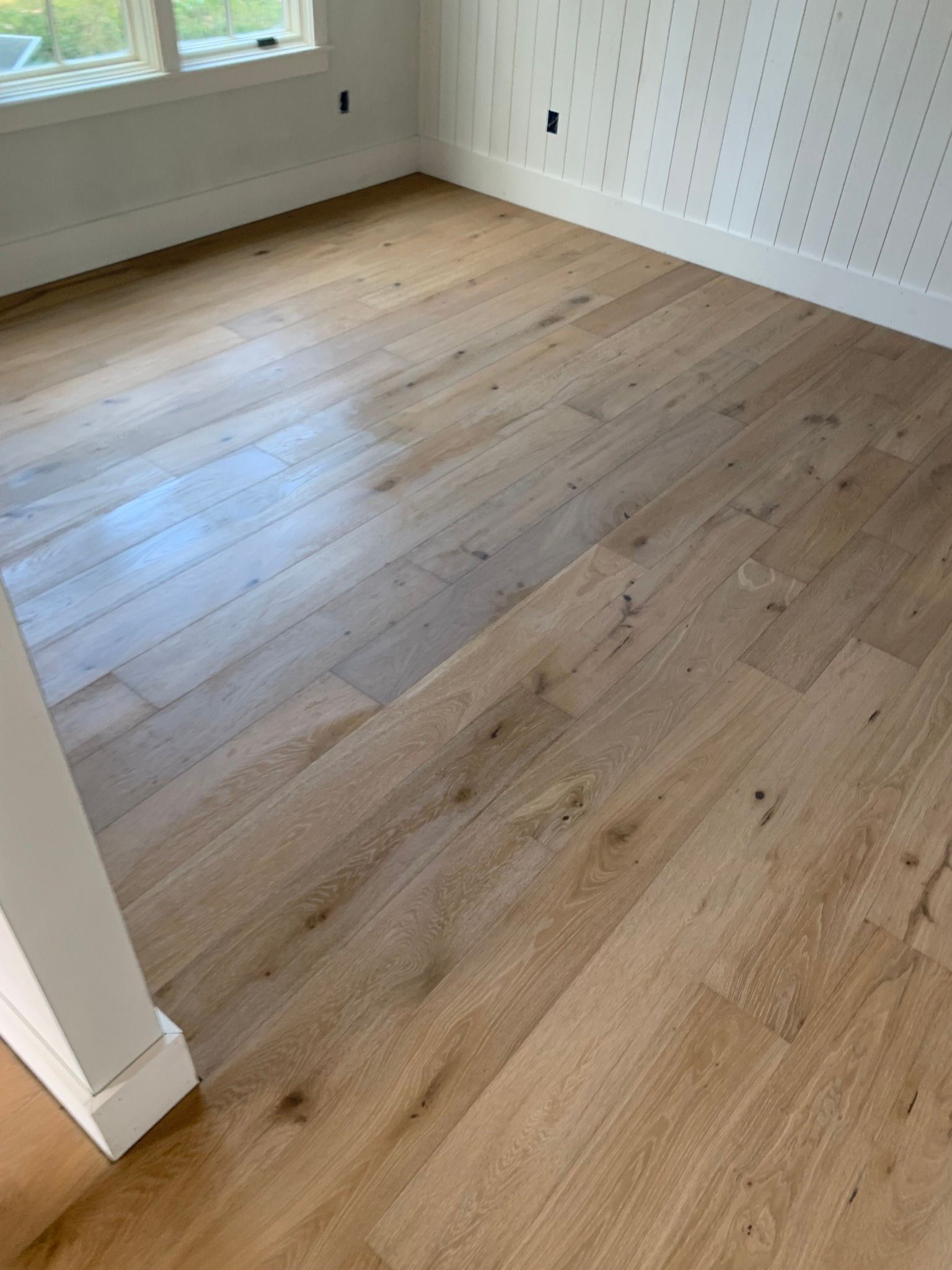 A room with a wooden floor and white walls.
