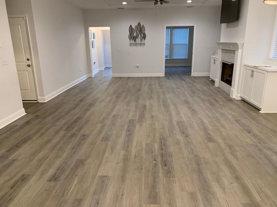 A living room with hardwood floors and a fireplace.
