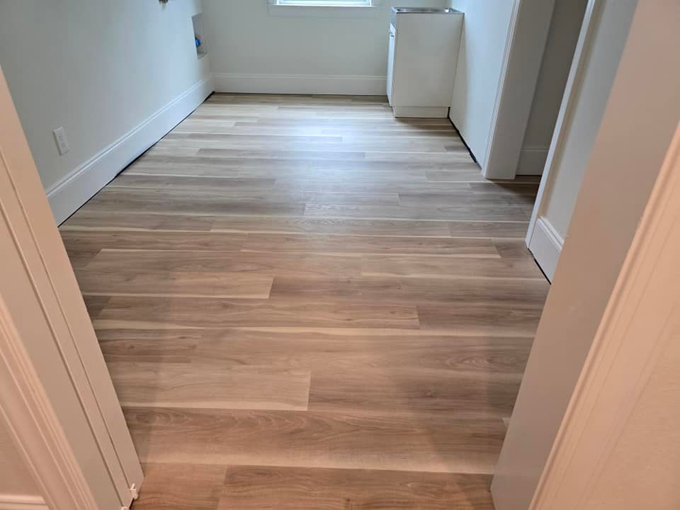 A room with a wooden floor and white walls.