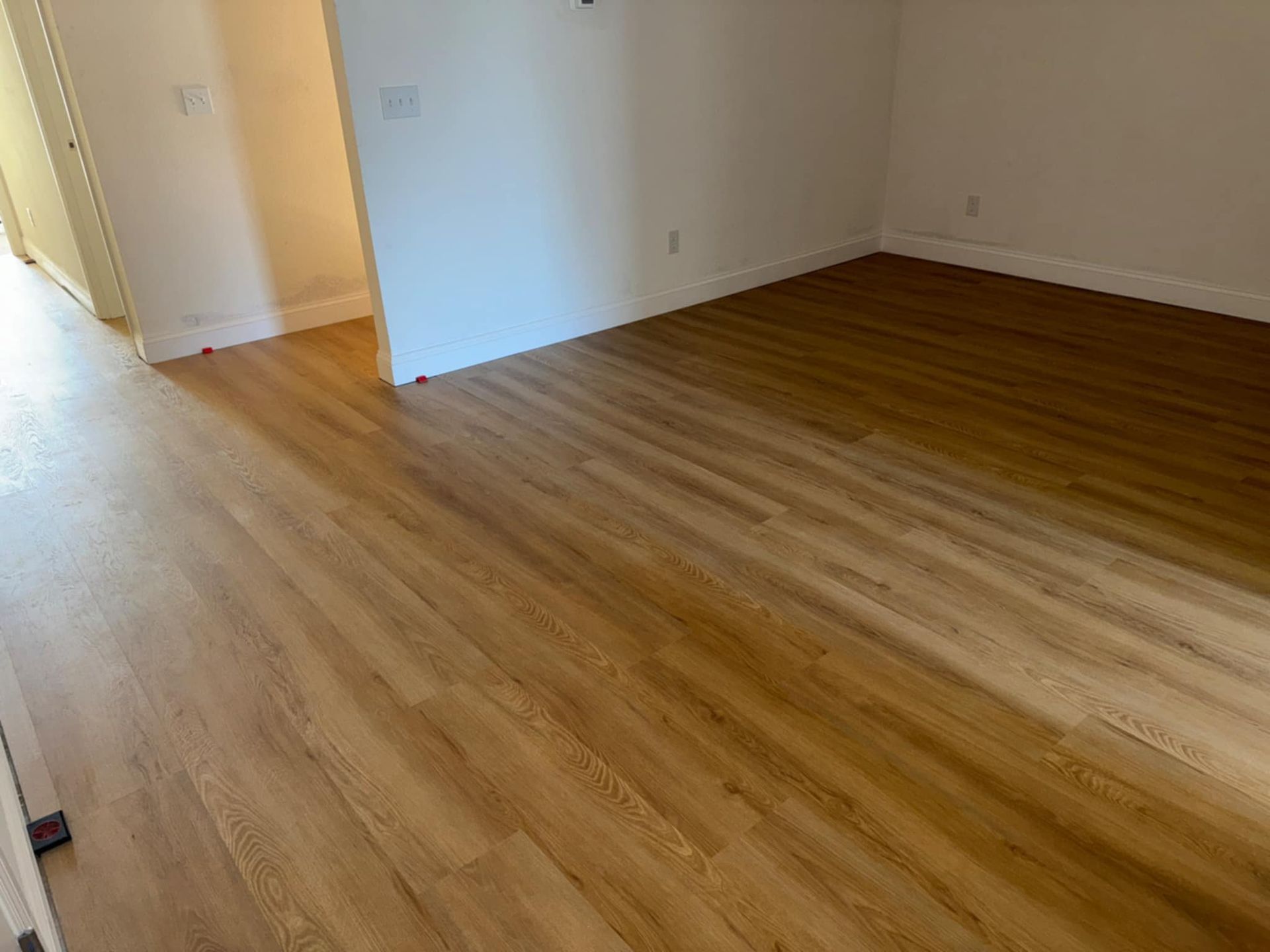 A room with a wooden floor and white walls.