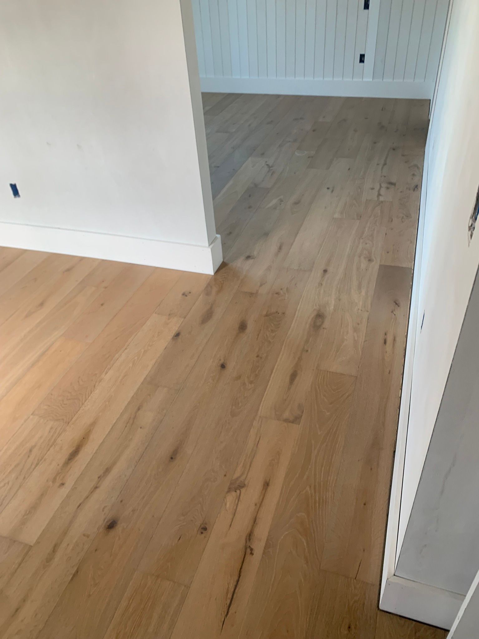 A room with a wooden floor and white walls.