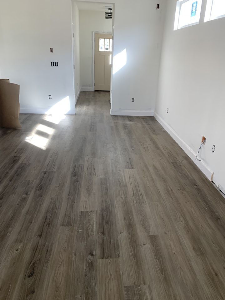A room with a wooden floor and white walls.