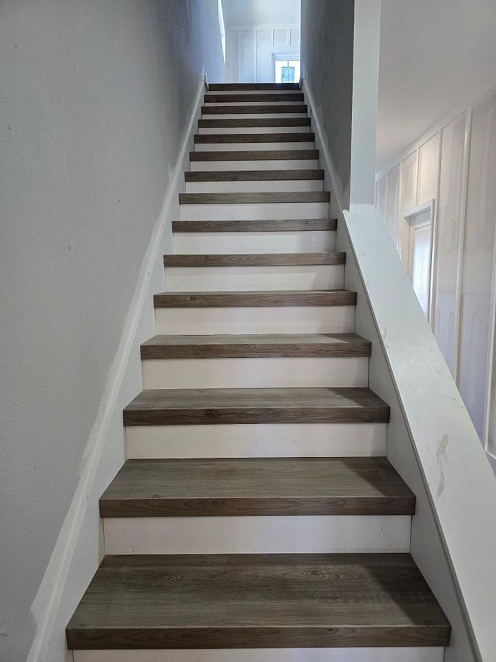 A set of wooden stairs leading up to the second floor of a house.