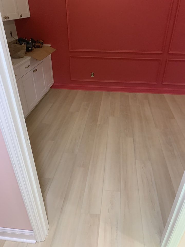 A room with a white floor and pink walls.