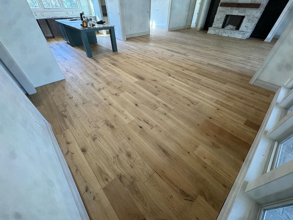 A living room with hardwood floors and a fireplace.