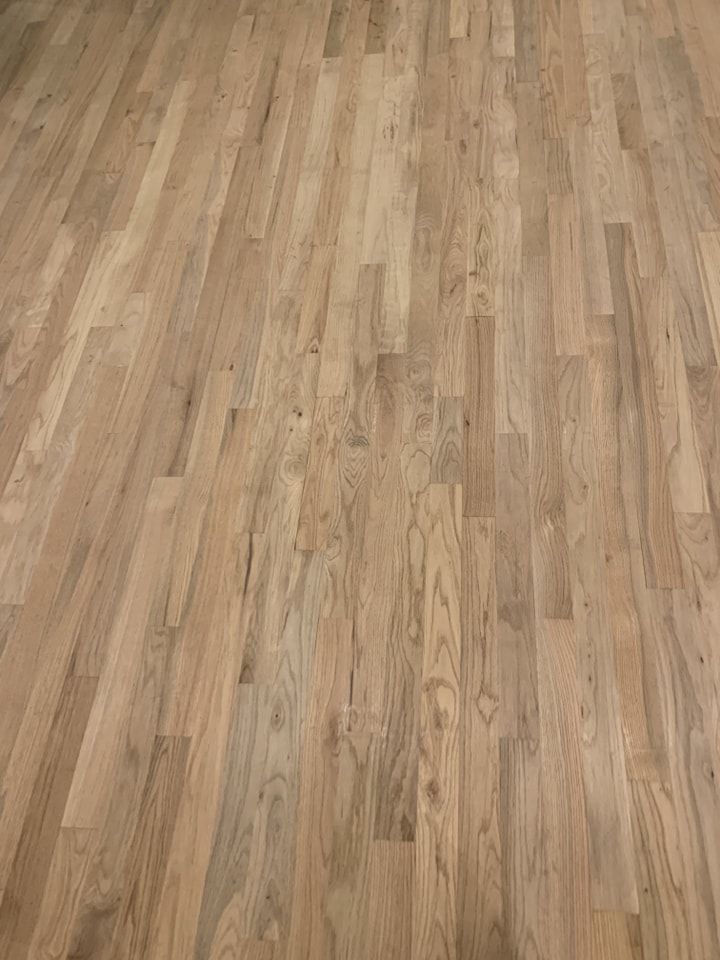 A close up of a wooden floor in a room.
