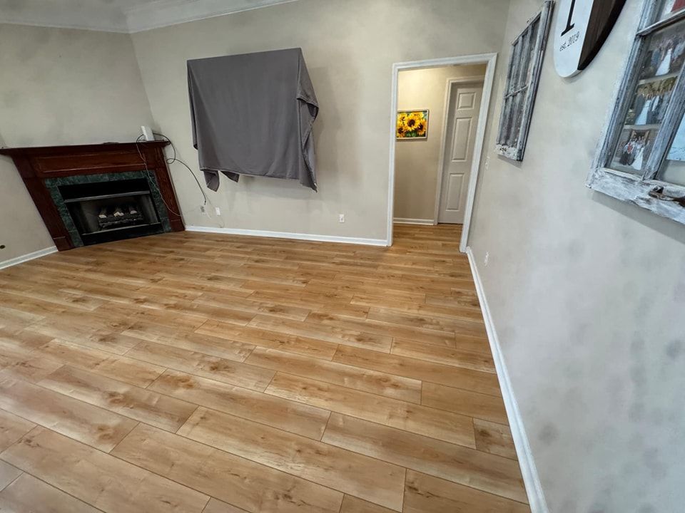 A living room with hardwood floors and a fireplace.