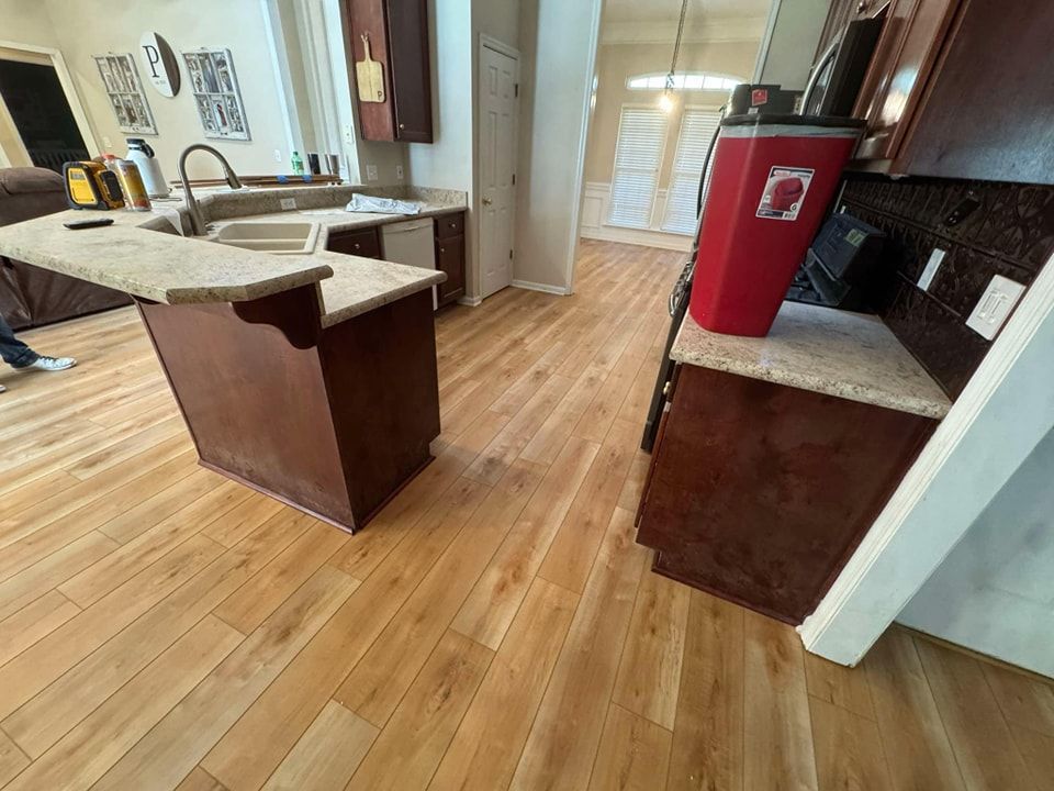 A kitchen with hardwood floors and a sink.