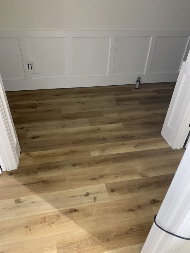 A room with hardwood floors and white walls.