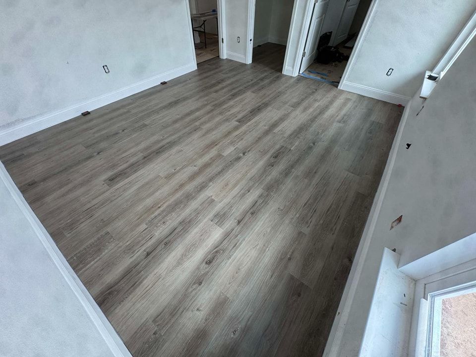 A room with a wooden floor and white walls.