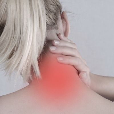 a woman is holding her neck because she has a neck pain
