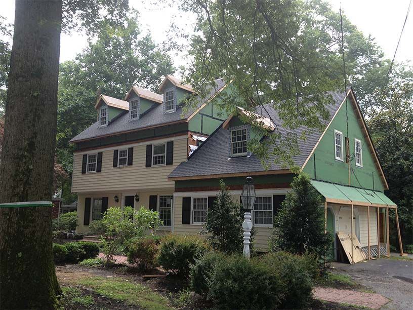 A house with a green awning on the side of it