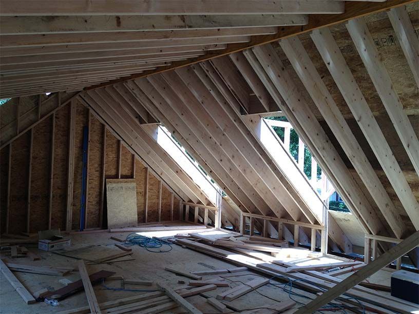 An attic under construction with a lot of wooden beams