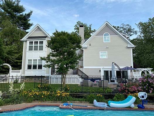 A large house with a swimming pool in front of it