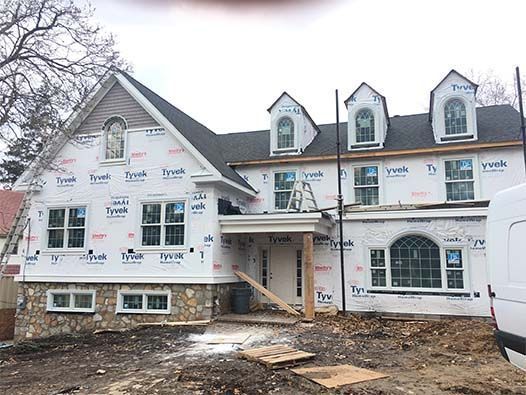 A large house is being built with a lot of windows.