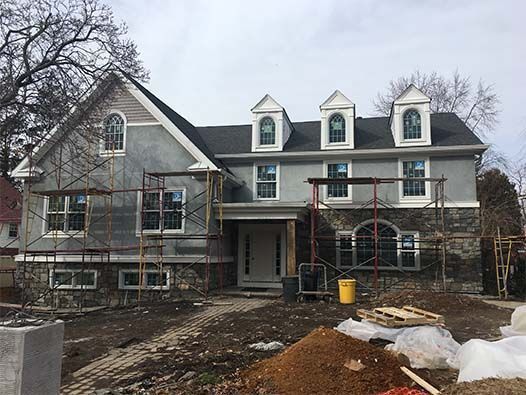 A large house is being built with scaffolding around it.