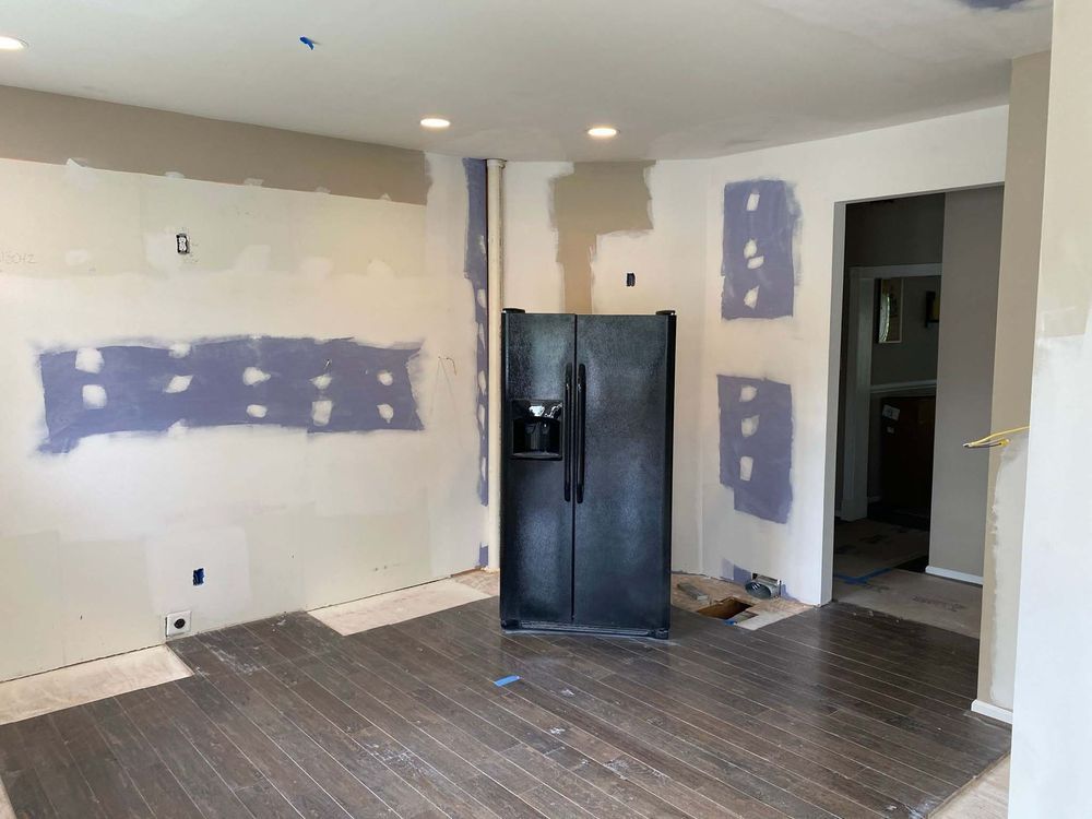 There is a refrigerator in the middle of the room.