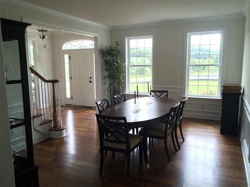 A dining room with a table and chairs and stairs