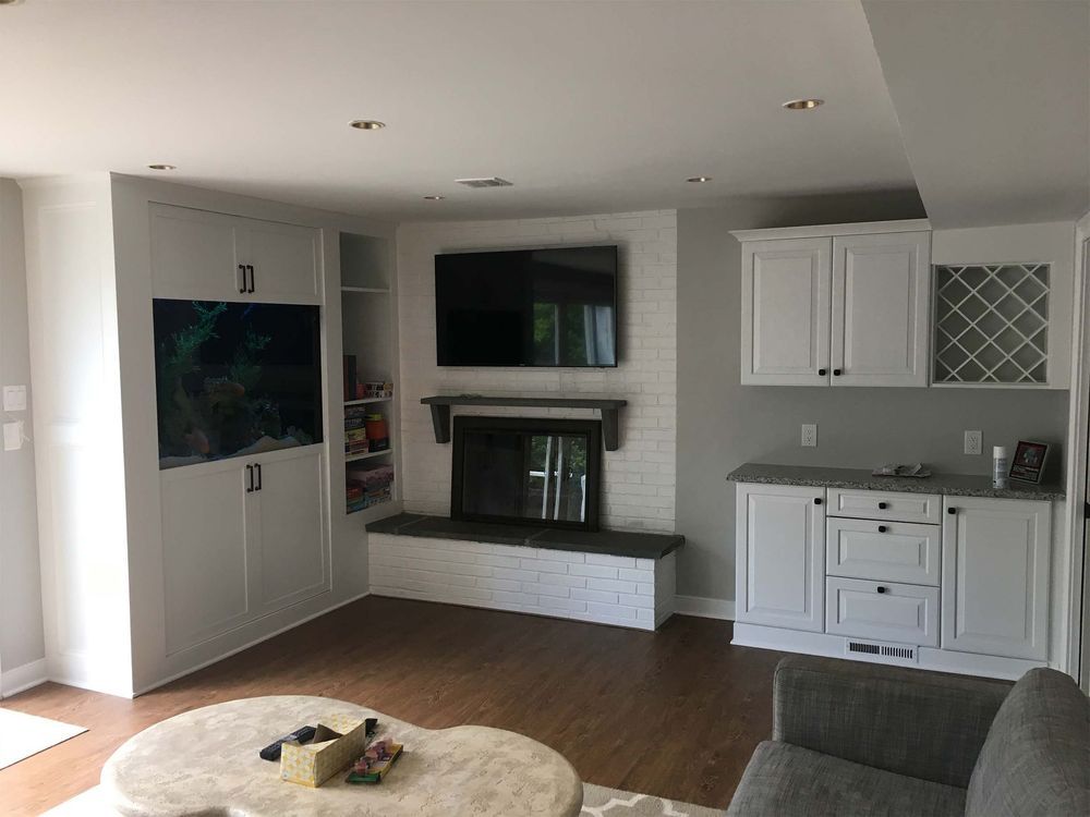 A living room with a fireplace and a flat screen tv.
