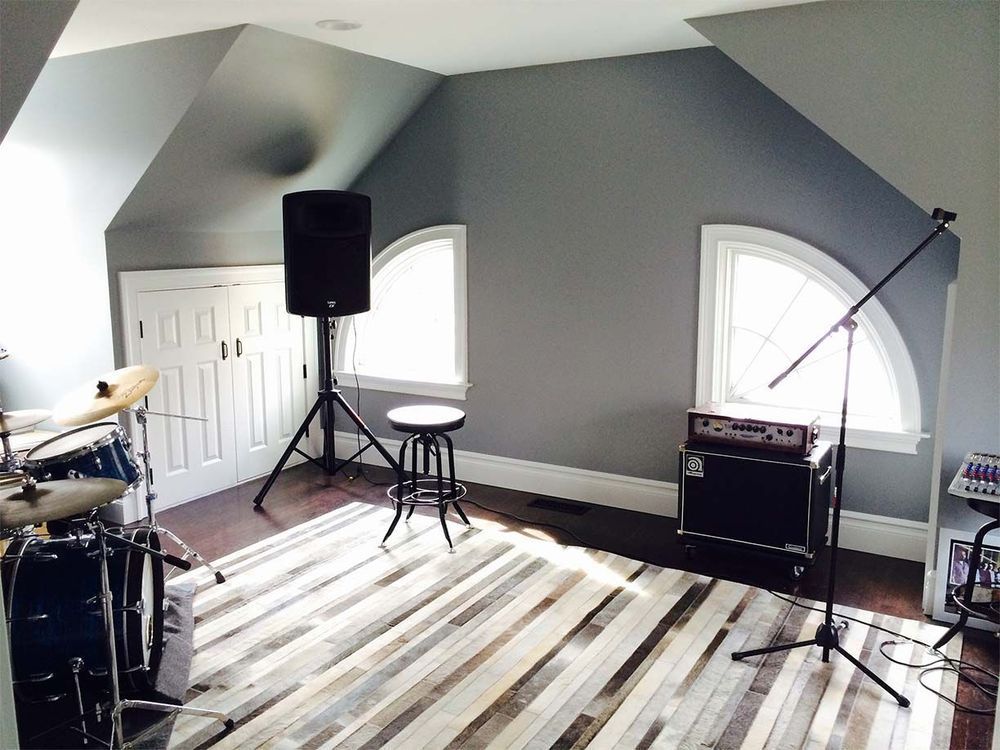 A room with a drum set and a microphone in it