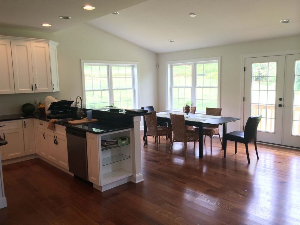 A kitchen with a table and chairs in it