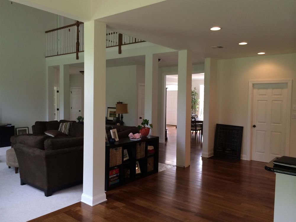 A living room with hardwood floors and white walls