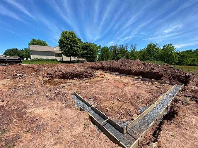 A construction site with a house in the background