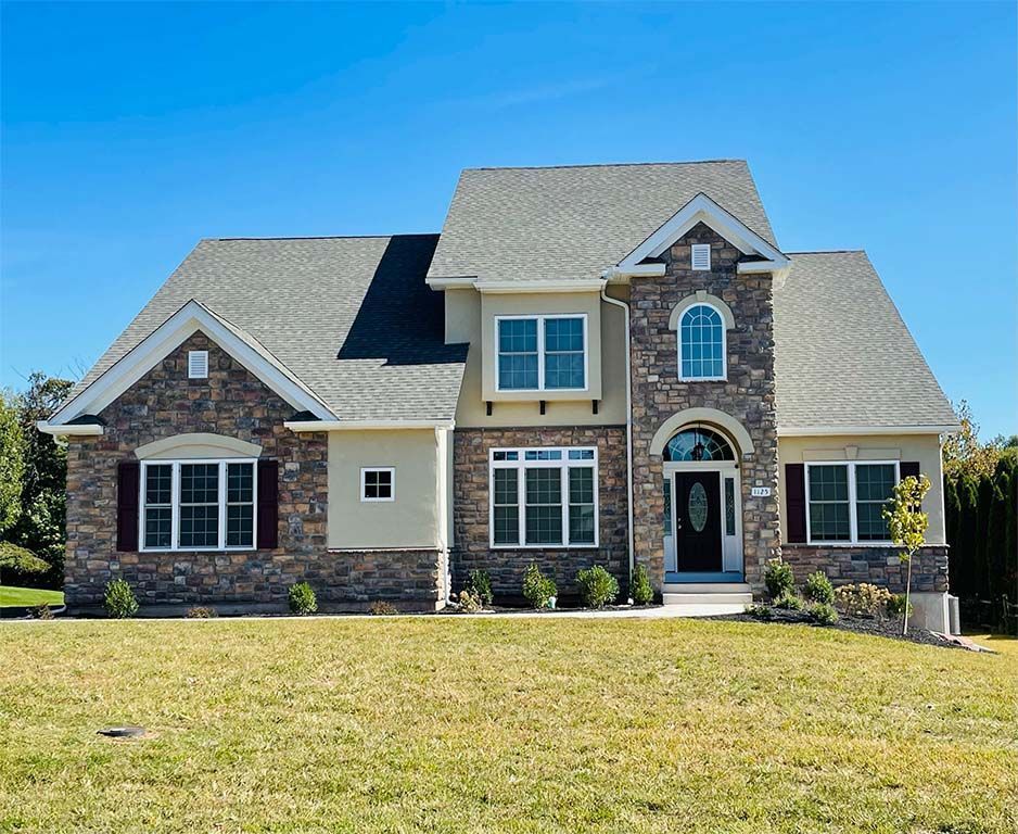 A large house with a large lawn in front of it