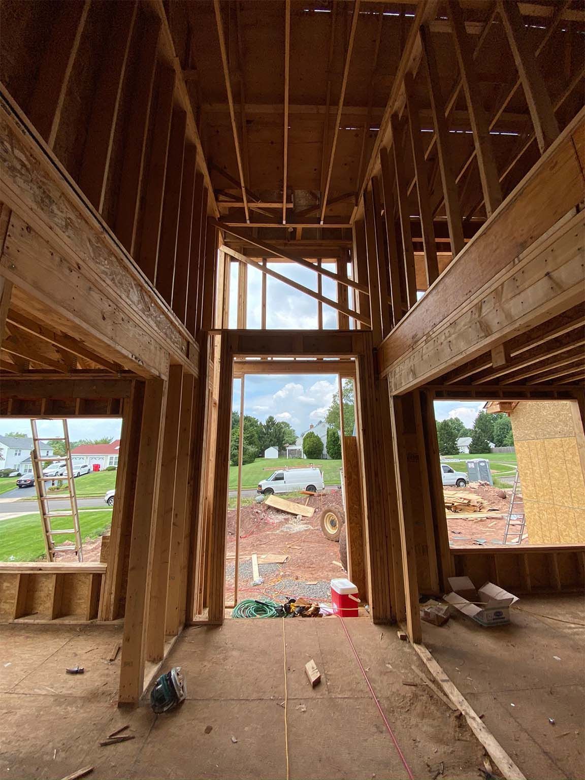 The inside of a house under construction with a large window.