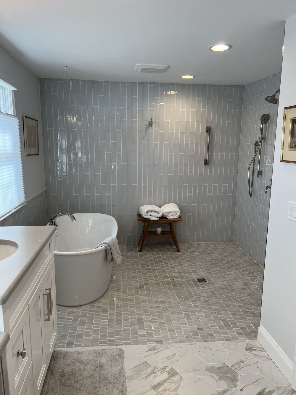 A bathroom with a tub and a walk in shower.