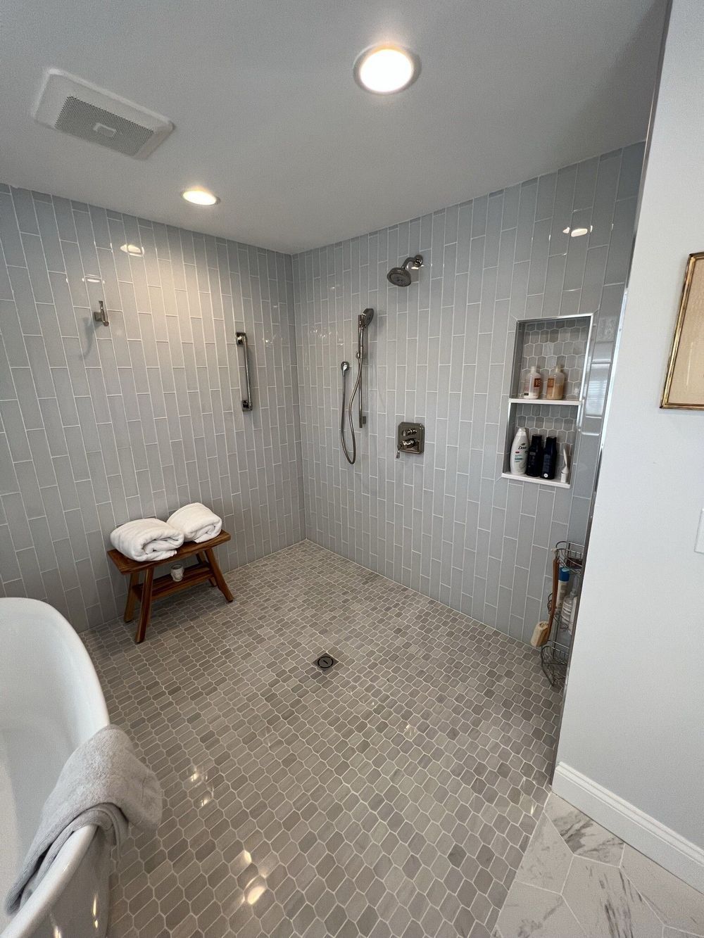 A bathroom with a walk in shower and a bathtub.