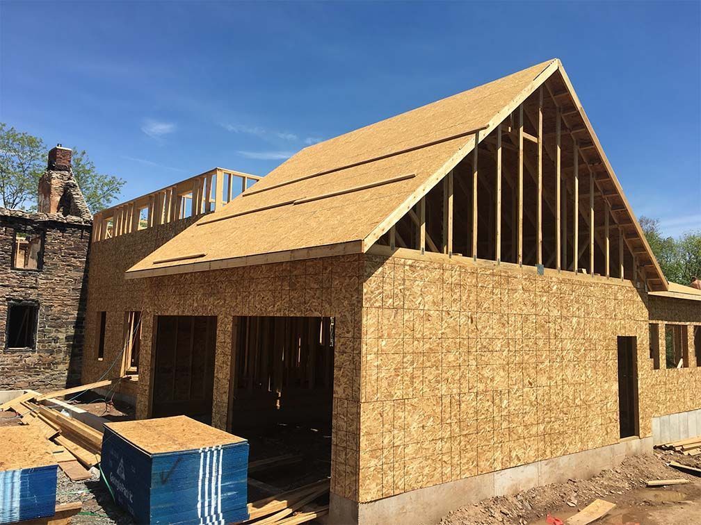 A house is being built with a wooden roof.