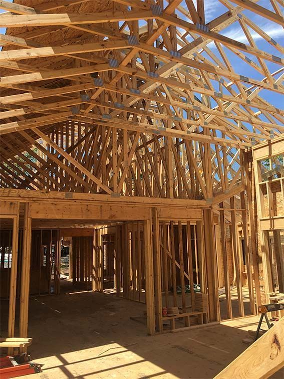 The inside of a house under construction with a lot of wooden beams.