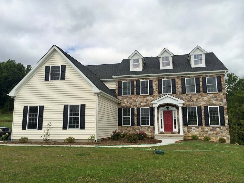 A large house with a red door and black shutters