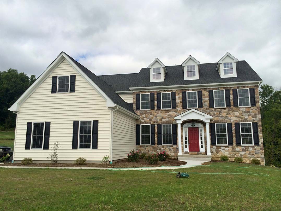 A large house with a red door and black shutters
