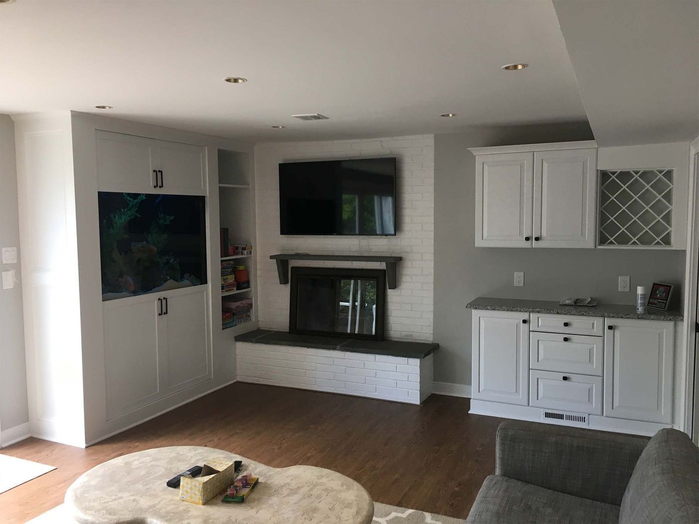 A living room with a fireplace and a flat screen tv.