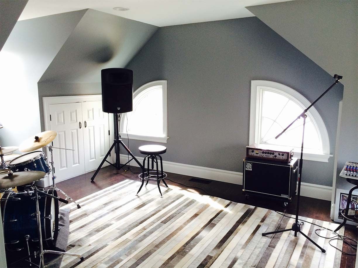 A room with a drum set and a microphone in it