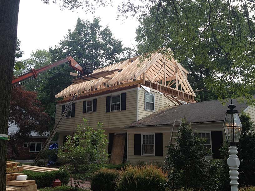 A house under construction with a crane in the background