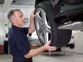 A man replacing a car wheel