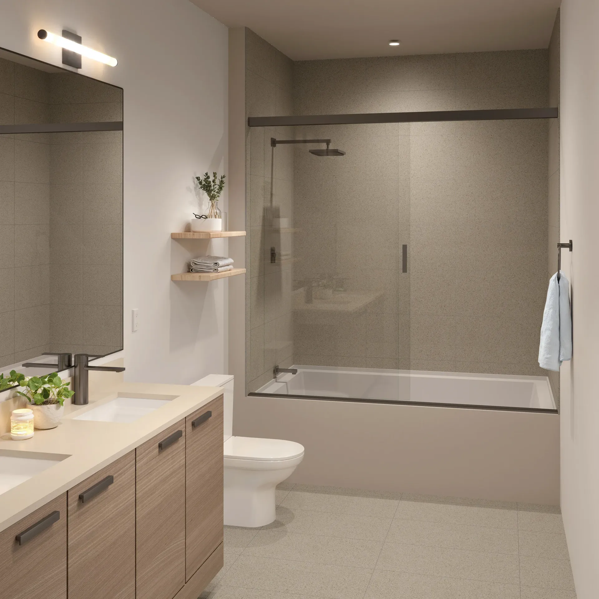Modern apartment bathroom with a double vanity, toilet, and glass-enclosed shower.