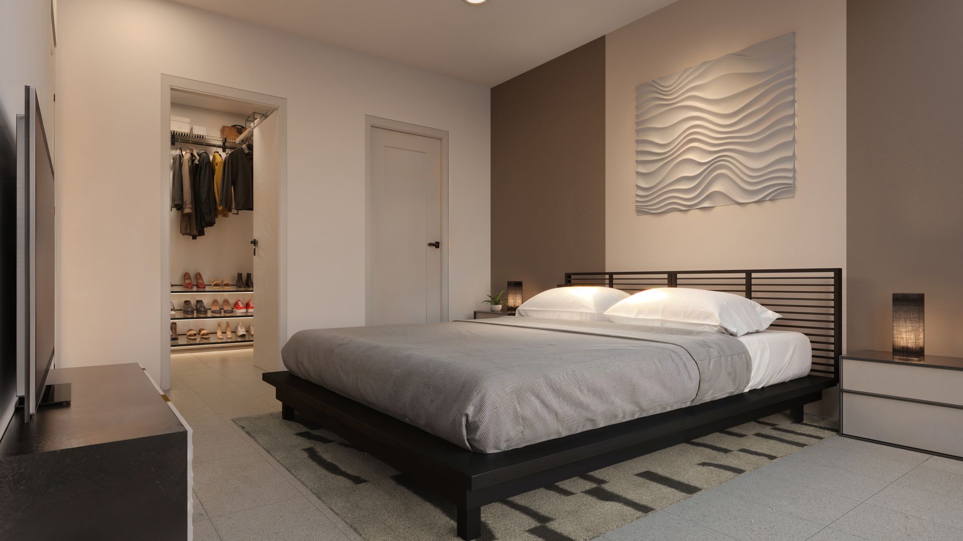 Woman with curly hair reads in bed, dog resting beside her in a sunlit room.