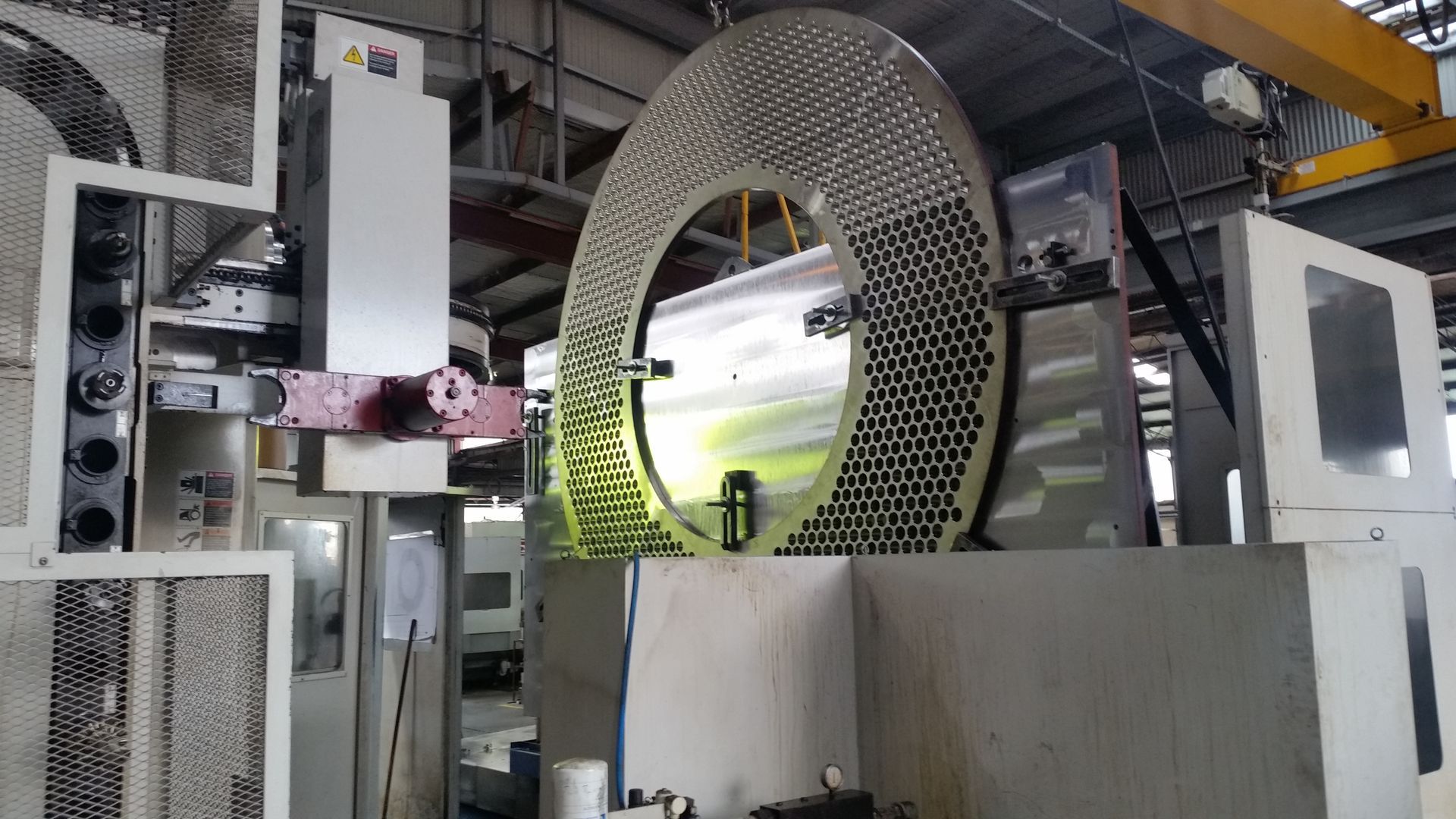 Large industrial machine with a perforated circular component.